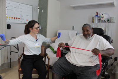 Therapist assisting patient with strengthening.